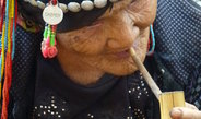 <p>An Akha woman in her eighties smoking a bamboo pipe. She is a respected and loved grandmother and mother to 11 children. The Akha are highlanders, scattered across the Ailao Mountains between the Mekong River and the Red River, and comprise a total population of 680,000.<br /><br />Photo: Ruijing Wang, Menglian, China, 2012<br />Max Planck Institute for Social Anthropology</p>