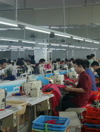 Workers in a family owned sport clothing factory in Shishi, China.