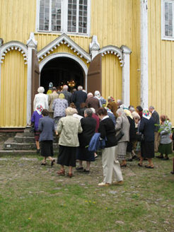 People entering church after procession. Whit Sunday. 2008.