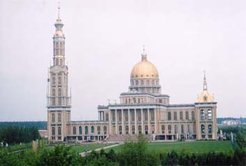The efflorescence of popular forms of religion is nowhere more evident than in Poland. This basilica, one of the largest in the world, was recently completed at the Marian shrine at the village of Lichen, Central Poland. The second half of the nineteenth century saw numerous Marian apparitions in most countries of Catholic Europe. The expansion of this pilgrimage site dates back to the 1960s, and all attempts in the socialist period to curtail the power of the church had the opposite effect. The stone (right) is believed by pilgrims such as this Roma woman to bear the footprints of Mary. The Lichen complex has been closely studied over many years by Poznan anthropologist Katarzyna Marciniak.