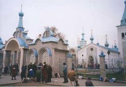 A Russian Orthodox church and a large monument to Lenin that dominated a central square are two contrasting signs of Russia's historical impact on the city of Bishkek, capital of predominantly Muslim Kyrgyzstan. The National History Museum, visible behind the Lenin statue, still devotes as much space to the myths and heroes of Marxism-Leninism as it does to Kyrgyz ethnic traditions (these photos were taken in April 2003, but the Lenin statue was removed overnight and without consultation in August 2003).