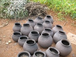 Freshly fabricated pots drying in the sun.