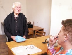 Elderly refugee woman seeks support at the Department for Refugees in Yerevan