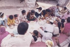 Breaking the traditional taboo: Men and women eating together in a religious sphere.