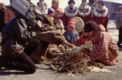 The spring festival in Tavaivaam, a village located at 20 minutes walk from Anadyr, the capital of Chukotka. In this re-enactment of the tundra Kilvei festival performed in the village, the mound of willow branches and antlers takes center stage, while the tent is located behind. The video camera seems also to have become part of the ritual.