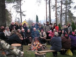Traditional gathering in the cemetery for burning of old crosses and prayers for the dead.