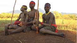 Young men resting during a second funeral ceremony