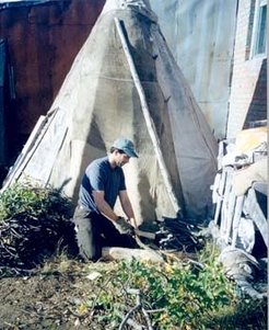 John Ziker chopping dwarf willow the Dolgan way for the chum (teepee) in the background, where the host family will smoke caribou meat, August 2001. The Dolgan way of chopping willow separates thicker pieces from branches and twigs into different piles.