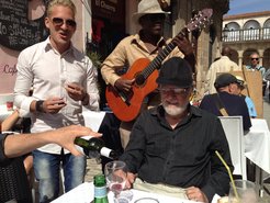 University students with musical talent can make good money busking in the old town (seated, David Harvey).