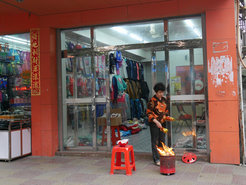 Worshipping the Earth God in front of one's shop.