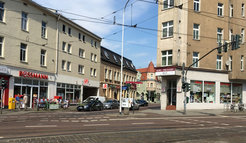 The shop of a large drugstore chain (left) and, on the opposite side of the road, a family-run drugstore founded in 1900.